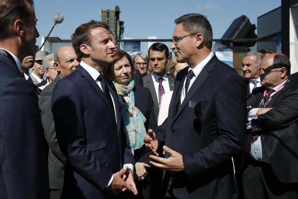 French President Emmanuel Macron talks with Eric Beranger, right, Chief Executive Officer of MBDA missile Systems, the 53rd International Paris Air Show at Le Bourget Airport near Paris, France, Monday June 17, 2019. The world's aviation elite are gathering at the Paris Air Show with safety concerns on many minds after two crashes of the popular Boeing 737 Max. (Benoit Tessier/Pool via AP)