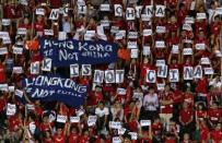 Hong Kong fans hold banners and character signs which read "Hong Kong is not China", during the 2018 World Cup qualifying match between Hong Kong and China, in Hong Kong, November 17, 2015. Less than a year after the Occupy protests, tensions were high going into match between Hong Kong and China. Fans booed the playing of the Chinese national anthem during the match, which ended in a 0-0 draw. REUTERS/Bobby Yip/File photo