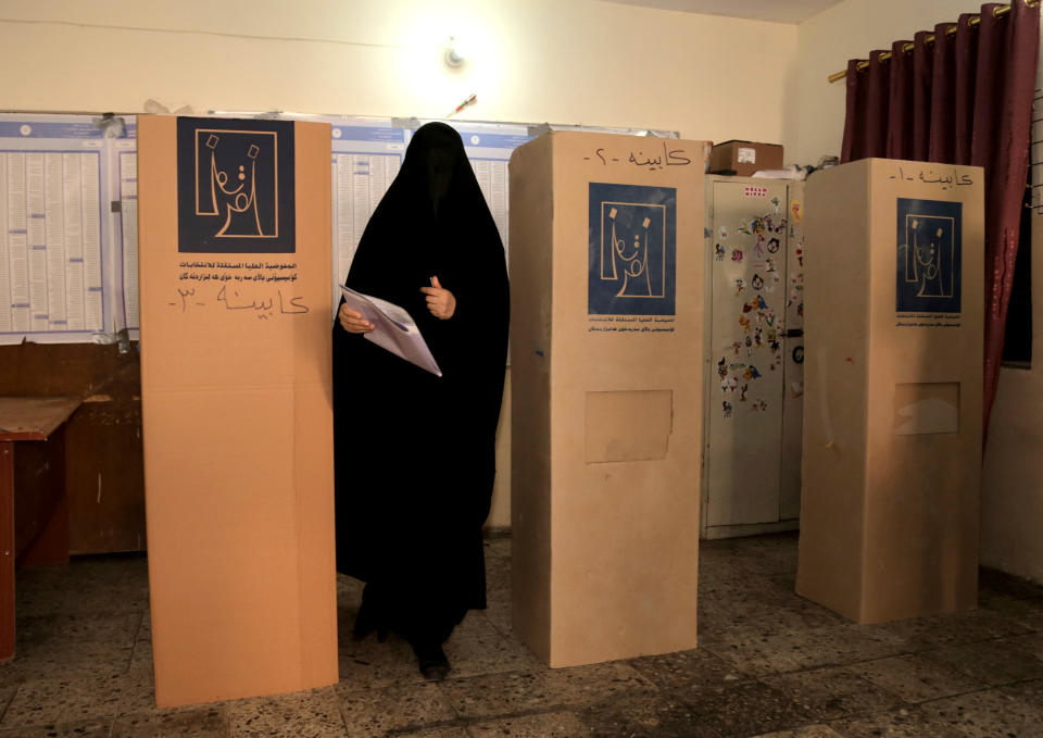 An Iraqi woman prepares to cast her vote at a polling center in Baghdad, Iraq, Wednesday, April 30, 2014. A key election for a new Iraqi parliament was underway on Wednesday amid a massive security operation as the country continued to slide deeper into sectarian violence more than two years after U.S. forces left the country. (AP Photo/ Khalid Mohammed)