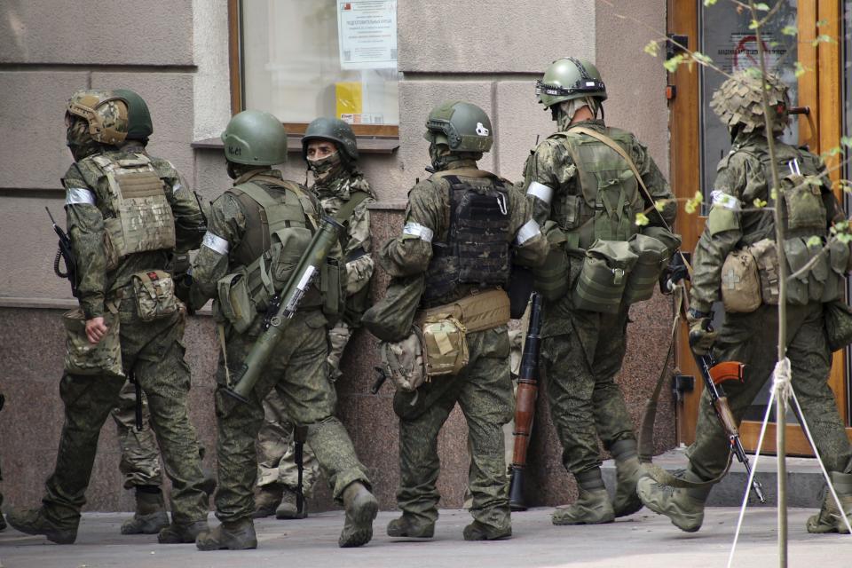 Russian servicemen walk along a street in Rostov-on-Don, Russia, Saturday, June 24, 2023. Russia's security services have responded to mercenary chief Yevgeny Prigozhin's declaration of an armed rebellion by calling for his arrest. In a sign of how seriously the Kremlin took the threat, security was heightened in Moscow, Rostov-on-Don and other regions. (Vasily Deryugin, Kommersant Publishing House via AP)