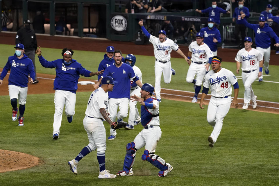 FILE - In this Oct. 27, 2020, file photo, the Los Angeles Dodgers celebrate at Globe Life Field after defeating the Tampa Bay Rays to win the baseball World Series in Game 6 in Arlington, Texas. The victory ended the neutral-site playoffs MLB held in 2020 at the stadium, where this year's postseason games are back and the home team Texas Rangers are playing in them there for the first time. (AP Photo/Tony Gutierrez, File)