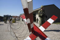 In this photo taken on Thursday, March 22, 2018, member of Kosovo Security Force (KSF) man a checkpoint during an exercise inside the barracks in the southern part of the ethnically divided town of Mitrovica. In a vote set for Friday, Dec. 14, 2018, Kosovo’s 120-seat parliament is expected to approve draft government-submitted legislation to turn an existing 4,000-strong paramilitary force, known as the Kosovo Security Force, into an expanded, lightly armed army. (AP Photo/Visar Kryeziu)