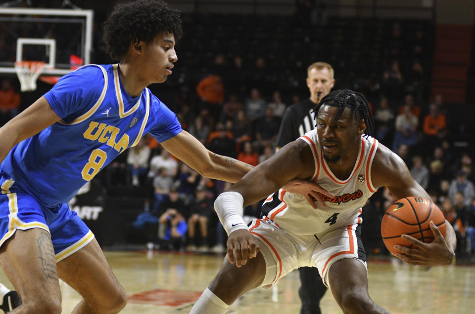 UCLA guard Ilane Fibleuil (8) defends against Oregon State guard Dexter Akanno (4) during the first half of an NCAA college basketball game Thursday, Dec. 28, 2023, in Corvallis, Ore. (AP Photo/Mark Ylen)