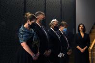 U.S. Secretary of State Mike Pompeo, second left, and his wife Susan, left, observe one minute of silence during their visit at the Jewish Museum in the northern city of Thessaloniki, Greece, Monday, Sept. 28, 2020. Pompeo said Monday the United States will use its diplomatic and military influence in the region to try to ease a volatile dispute between NATO allies Greece and Turkey over energy rights in the eastern Mediterranean. (AP Photo/Giannis Papanikos, Pool)