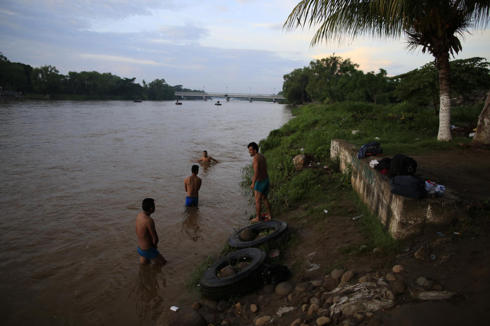 A group of Guatemalan and Honduran migrants who have been working in Ciudad Hidalgo, Mexico, bathe in the Suchiate river, Friday, June 14, 2019. Raftsmen and riverfront business operators said the flow of migrants through the crossing has decreased noticeably since the announcement a few days ago that Mexico's new National Guard would be deploying to the border. (AP Photo/Rebecca Blackwell)