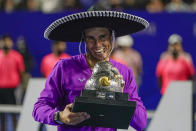 Spain's Rafael Nadal poses with his trophy on the court after he defeated Britain's Cameron Norrie in the final match at the Mexican Open tennis tournament in Acapulco, Mexico, Saturday, Feb. 26, 2022. (AP Photo/Eduardo Verdugo)