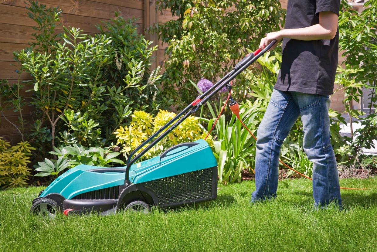 teen mowing the lawn