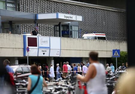 People return to the university clinic in Steglitz, a southwestern district of Berlin, July 26, 2016 after a doctor had been shot at and the gunman had killed himself. REUTERS/Hannibal Hanschke/File Photo