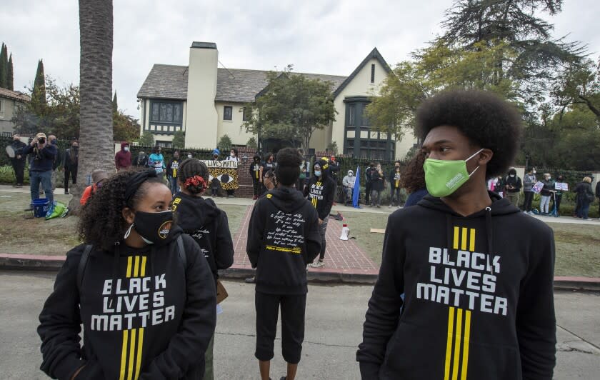 LOS ANGELES, CA - DECEMBER 07: Demonstrators prepare for a closing prayer in front of Getty House, the residence of Los Angeles Mayor Eric Garcetti, to protest any attempt by the Biden administration to appoint him to a cabinet post Monday, Dec. 7, 2020 in Los Angeles, CA. (Brian van der Brug / Los Angeles Times)