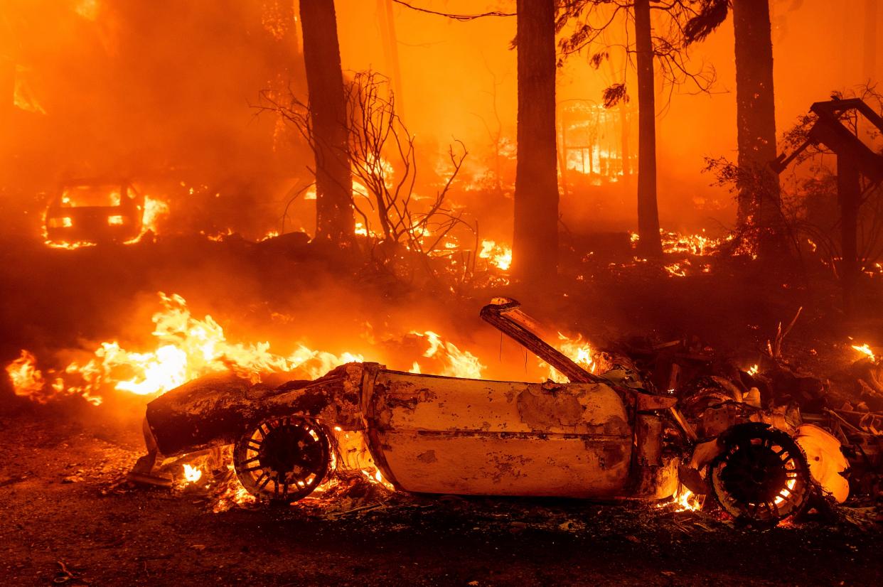 Flames consume vehicles as the Dixie Fire tears through the Indian Falls community in Plumas County, Calif. on Saturday, July 24, 2021. The fire destroyed multiple residences in the area.