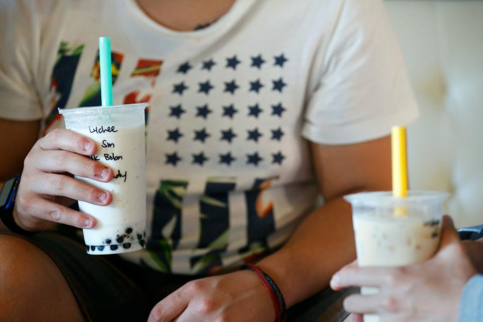 Juan Alejandro (left) and Andy Nguyen drink milk tea beverages at the newly opened La Boba cafe in Springfield, Mo. on Aug. 24, 2016.