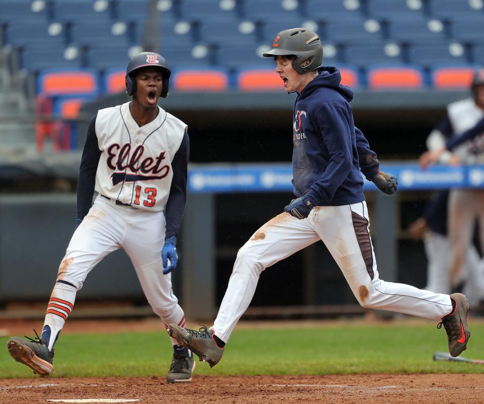 Ellet starting pitcher Chase Merring, right, celebrates with right fielder Duane Brown as he scores on two Firestone throwing errors during the fourth inning of the City Series baseball championship at Canal Park on Wednesday. Ellet won 3-2.