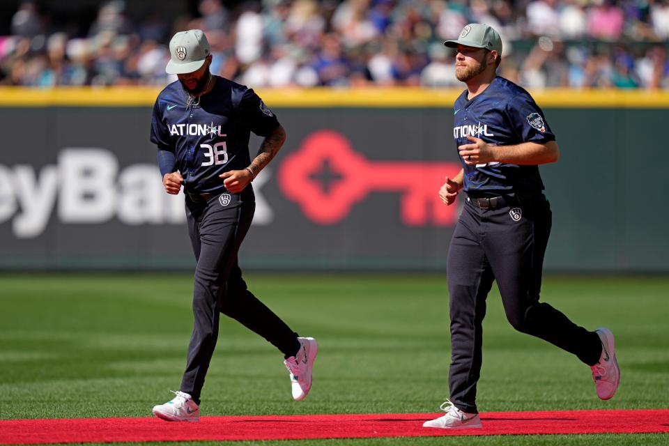 Devin Williams of the Milwaukee Brewers (38) and  pitcher Corbin Burnes of the Milwaukee Brewers (39) take the field before the 2023 all-star game in Seattle on July 11, 2023.