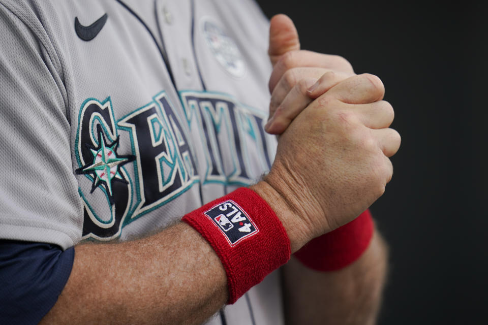 Seattle Mariners manager Scott Servais wears wrist bands in honor of Lou Gehrig Day prior to a baseball game against the Baltimore Orioles, Thursday, June 2, 2022, in Baltimore. (AP Photo/Julio Cortez)