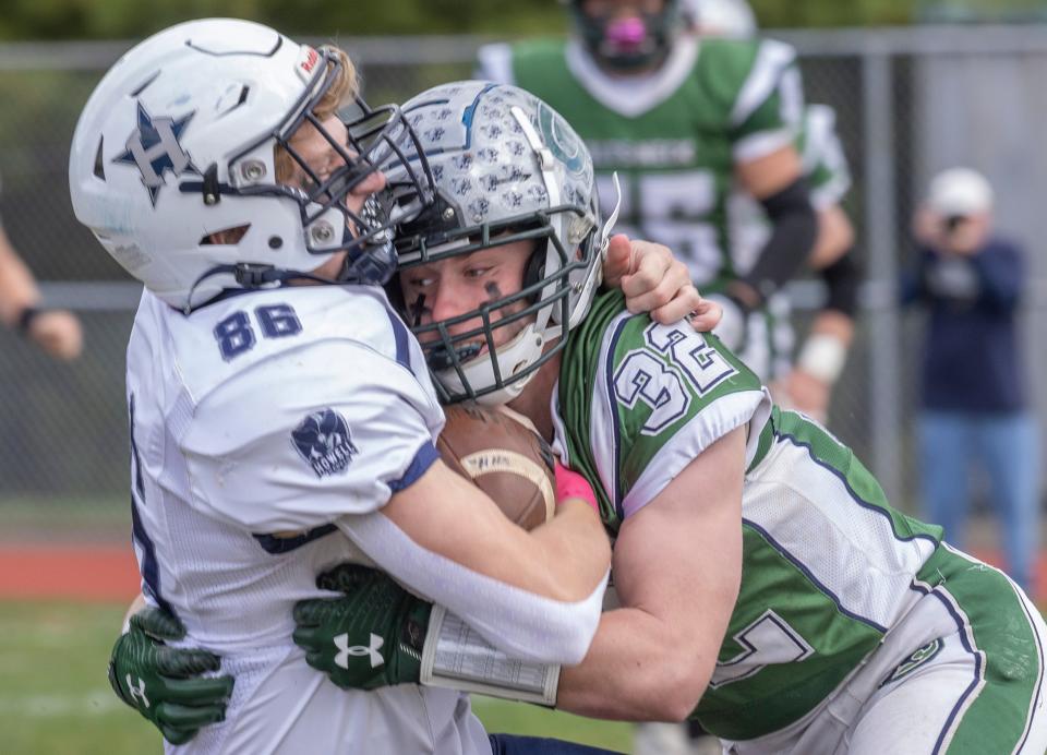 Howell Declan Flaherty is brought down by Will Surdez in first half action. Colts Neck football defeats Howell in Colts Neck, NJ on October 8, 2022. 