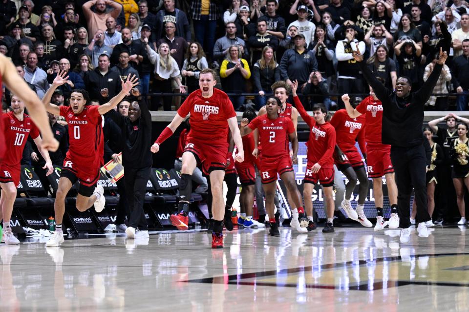 The Rutgers Scarlet Knights celebrate defeating the top-ranked Purdue Boilermakers at Mackey Arena in West Lafayette, Indiana.