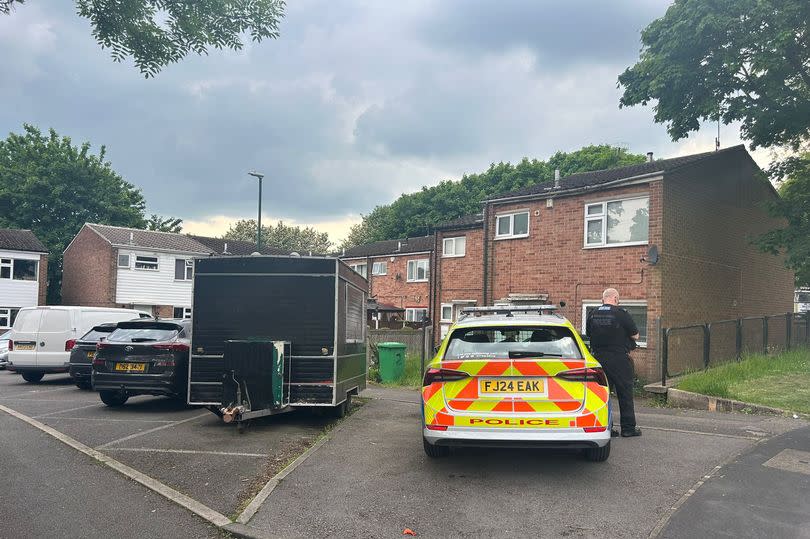 Police car with officer at side, outside a house on Newmarket Road, Bulwell