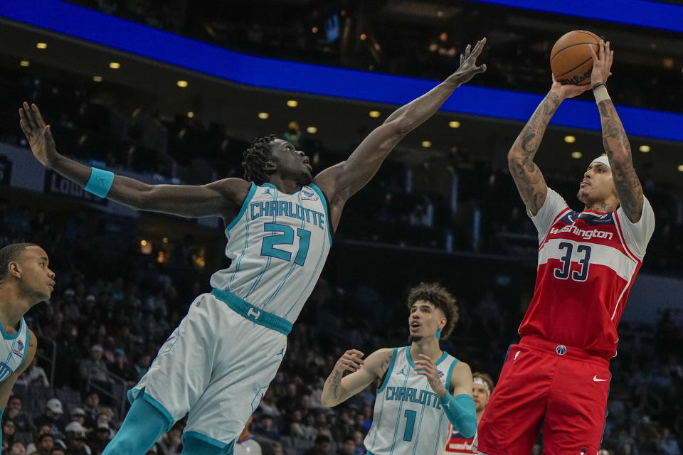 Washington Wizards forward Kyle Kuzma shoots over Charlotte Hornets forward JT Thor during the first half of an NBA basketball game on Wednesday, Nov. 22, 2023, in Charlotte, N.C. (AP Photo/Chris Carlson)