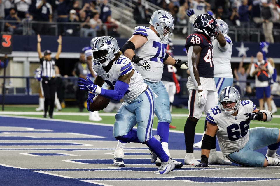 Dallas Cowboys running back Ezekiel Elliott (21) scores a touchdown during the second half of an NFL football game against the Houston Texans, Sunday, Dec. 11, 2022, in Arlington, Texas. (AP Photo/Michael Ainsworth)