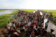 Rohingya refugees who crossed the border from Myanmar a day before, wait to receive permission from the Bangladeshi army to continue their way to the refugee camps, in Palang Khali, Bangladesh October 17, 2017. REUTERS/Jorge Silva