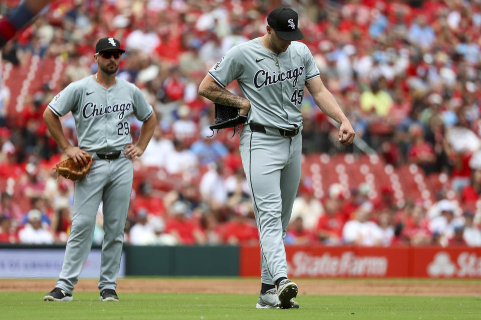 Chicago White Sox starting pitcher Garrett Crochet, right, stretches his calf after being hit by a ball off the bat of St. Louis Cardinals' Lars Nootbaar during the third inning of a baseball game Sunday, May 5, 2024, in St. Louis. (AP Photo/Scott Kane)
