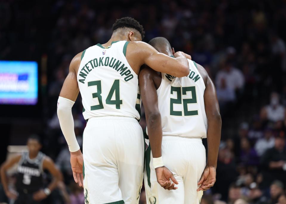 The Milwaukee Bucks' Giannis Antetokounmpo puts his arm around teammate Khris Middleton during a game last season.