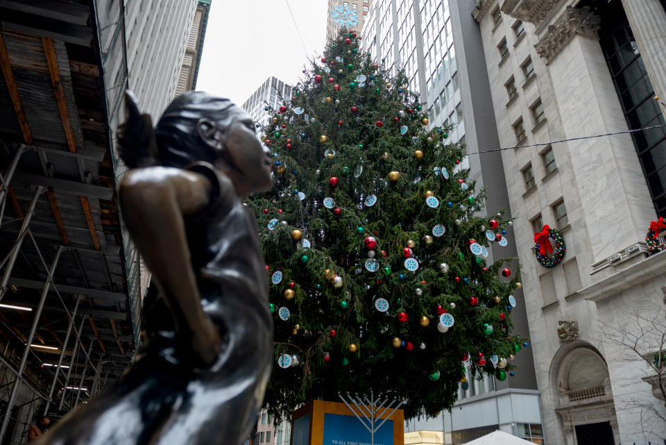 NEW YORK, NEW YORK - DECEMBER 02: A large Christmas Tree is displayed near the Fearless Girl Statue in front of the New York Stock Exchange on December 02, 2020 in New York City. (Photo by Alexi Rosenfeld/Getty Images)