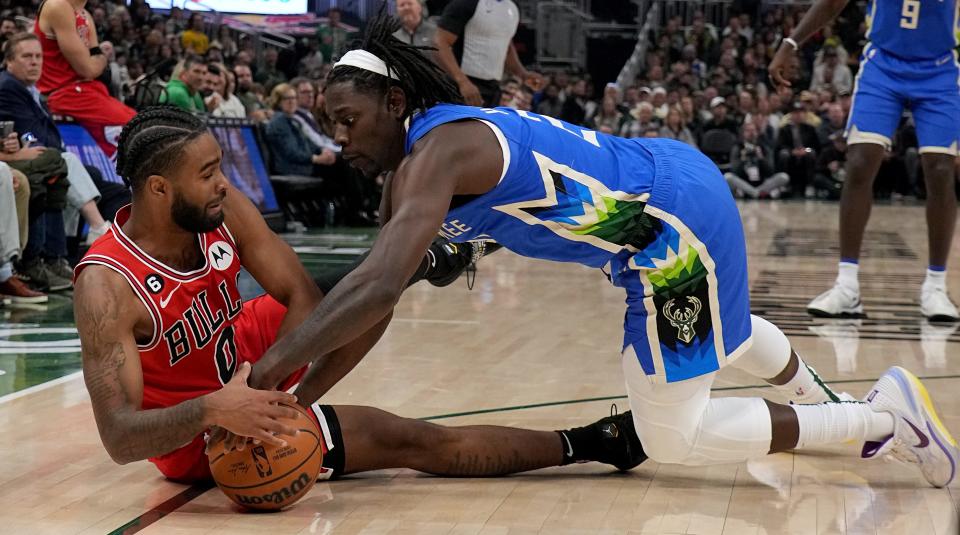 Chicago Bulls guard Coby White and Milwaukee Bucks guard Jrue Holiday scramble for the ball during the first half of their game Wednesday night at Fiserv Forum.