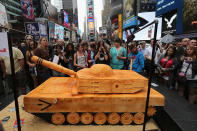 NEW YORK, NY - JUNE 14: Tourists photograph a 500 pound cake in the shape of a tank after watching a ceremony marking the U.S. Army's 237th anniversary on June 14, 2012 in Times Square in New York City. U.S. Army Chief of Staff Gen. Raymond Odierno cut the cake before swearing in16 new recruits during the event. ''Cake Boss'' reality show Buddy Valastro helped Odierno cut the cake, which Valastro said took eight of his staff three days to prepare for the event. (Photo by John Moore/Getty Images)