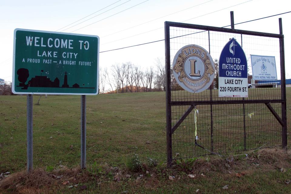 In this Thursday, Nov. 7, 2013 photo, a sign welcomes people to Lake City, Tenn. Residents are considering changing the town's name to Rocky Top in order to cash in on the famous bluegrass song. The city took the first step Thursday, when the council voted in favor of the change. (AP Photo/Travis Loller)