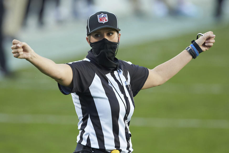 FILE - Down Judge Sarah Thomas gestures during an NFL football game between the Denver Broncos and the Carolina Panthers in Charlotte, N.C., in this Sunday, Dec. 13, 2020, file photo. Sarah Thomas will cap her sixth NFL season by becoming the first female to officiate the Super Bowl in NFL history. Thomas, a down judge, is part of the officiating crew announced Tuesday, Jan. 19, 2021, by the NFL. (AP Photo/Brian Westerholt, File)