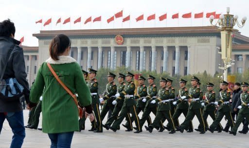 Paramilitary police march in Beijing's Tiananmen Square on November 7. Areas of central Beijing near the Great Hall of the People were swarming with police, and authorities have reportedly taken such measures as banning sales of knives