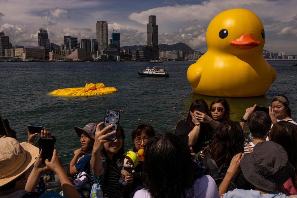 An art installation called "Double Ducks" by Dutch artist Florentijn Hofman as one of the duck is deflated at Victoria Harbour in Hong Kong, Saturday, June 10, 2023.