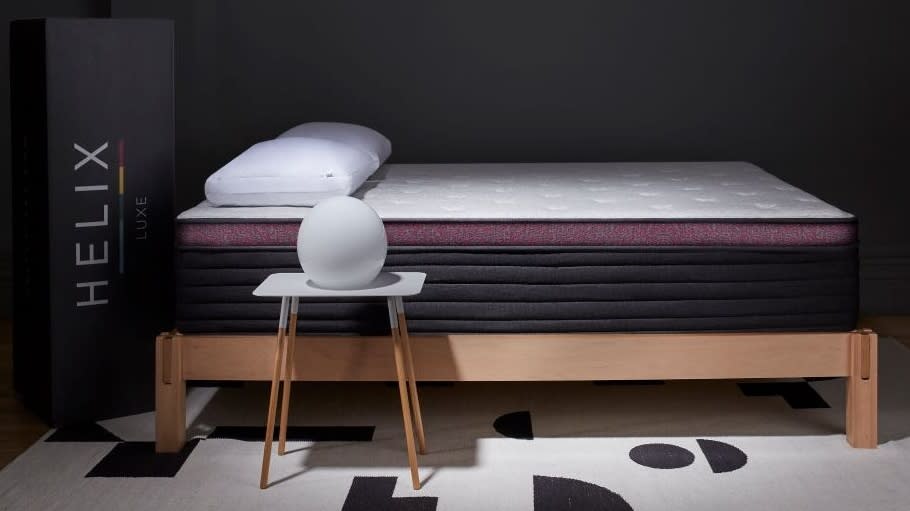  Helix Dusk Luxe Mattress review: image shows the mattress on a wooden bed in a dark bedroom. 