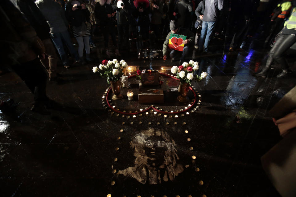 A man lights candles during a protest, in Banja Luka, Bosnia on Sunday, Dec. 30, 2018. Several thousand Bosnians have rallied in support of the man whose quest for the truth about his son’s death has turned into a wider movement for justice and rule of law in the Balkan country. The protest on Sunday demanded the ouster of Bosnian Serb Interior Minister Dragan Lukac and top police officials over the death in March of 21-year-old David Dragicevic. (AP Photo/Amel Emric)