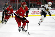 FILE - In this May 6, 2021, file photo, Carolina Hurricanes' Dougie Hamilton (19) skates with the puck against the Chicago Blackhawks during the third period of an NHL hockey game in Raleigh, N.C. The Devils agreed to term with Hamilton on a $63 million, seven-year contract. It's the most lucrative deal completed on the first day of NHL free agency. (AP Photo/Karl B DeBlaker, File)