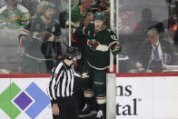 Minnesota Wild left wing Matt Boldy (12) pleads with official linesman Jesse Marquis (86) after a penalty for tripping was called during the third period of an NHL hockey game against the Chicago Blackhawks Saturday, March 25, 2023, in St. Paul, Minn. Minnesota won 3-1. (AP Photo/Stacy Bengs)