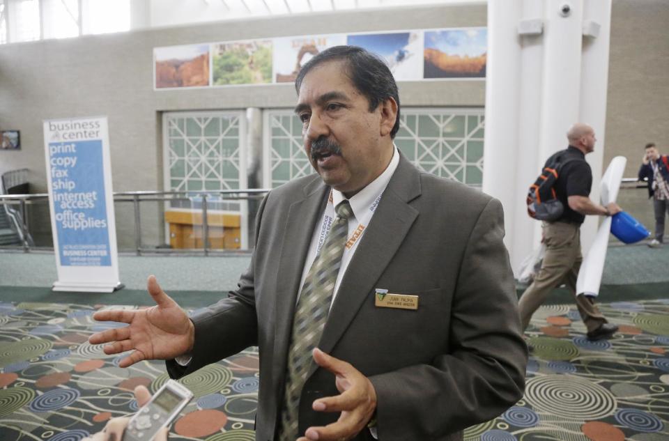 Juan Palma, Utah State Director for the Bureau of Land Management speaks with reporters during the Outdoor Recreation Summit Thursday, May 8, 2014, in Salt Lake City. The U.S. Bureau of Land Management is warning its workers in Utah to be on alert after two men threatened an agency wrangler on Interstate 15 about 90 miles south of Salt Lake City. (AP Photo/Rick Bowmer)