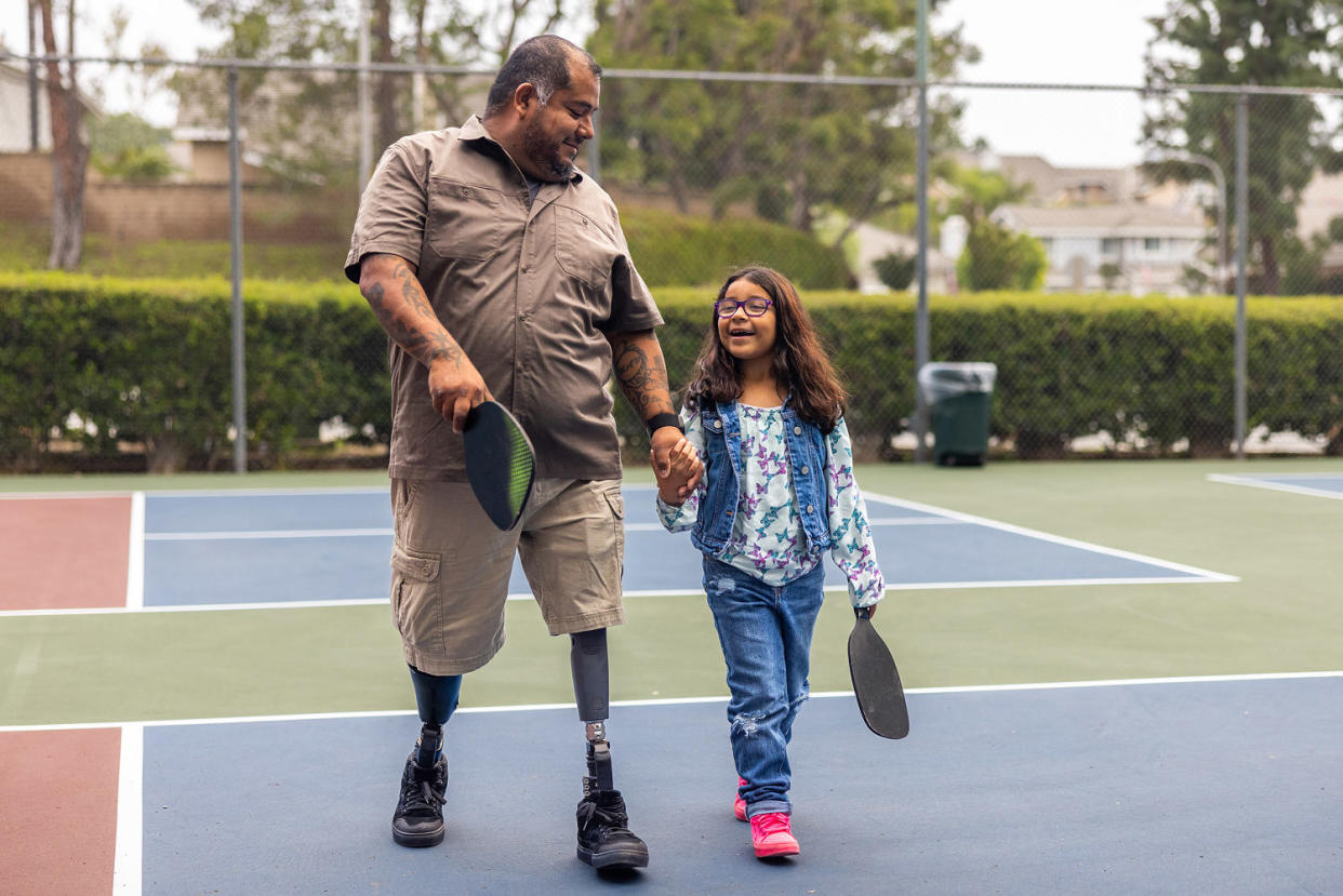 Father-Daughter Bond: Disabled Hispanic Veteran Plays Pickleball with 7-Year-Old Daughter (adamkaz / Getty Images)