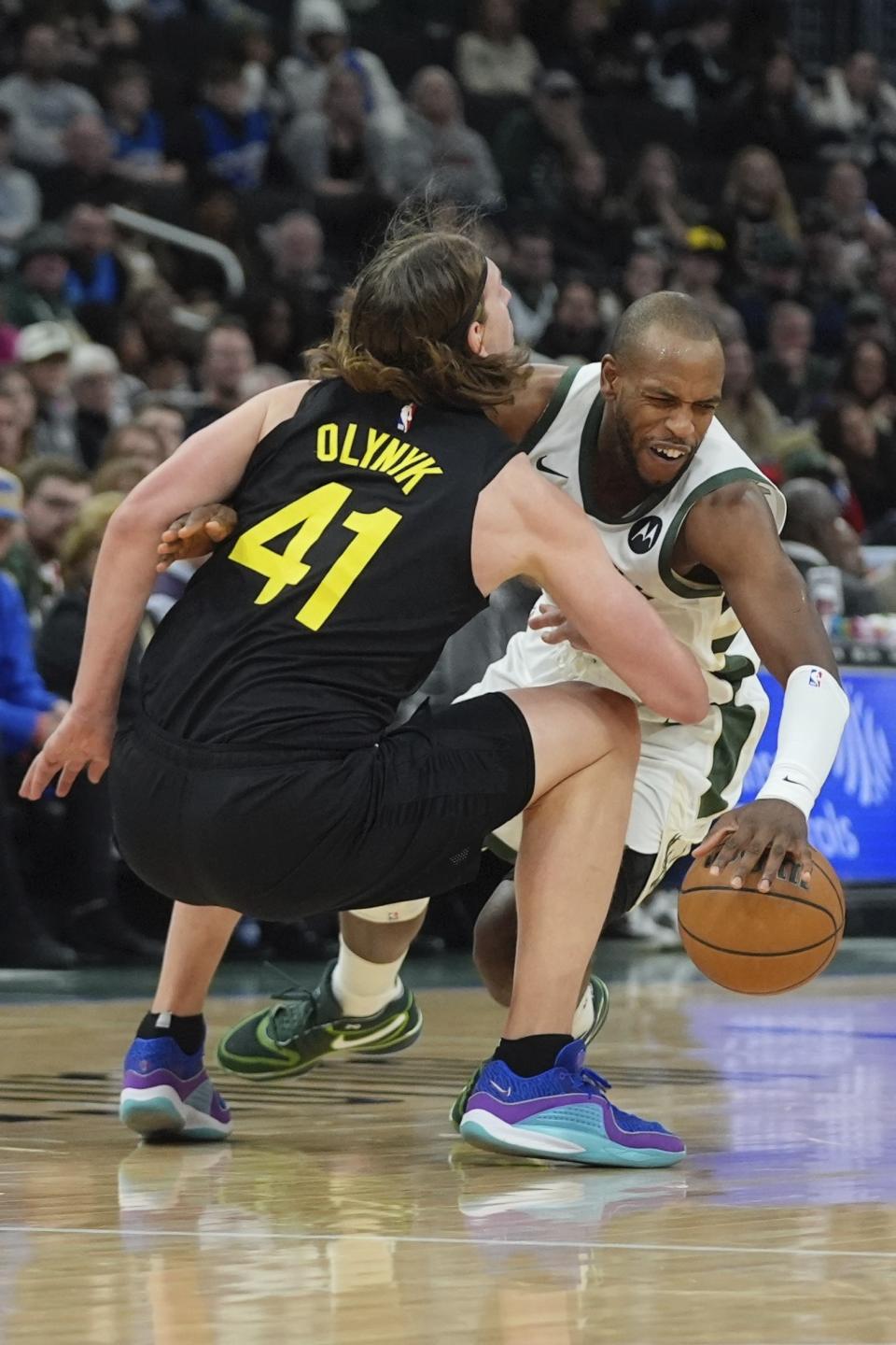 Utah Jazz's Kelly Olynyk fouls Milwaukee Bucks' Khris Middleton during the first half of an NBA basketball game Monday, Jan. 8, 2024, in Milwaukee. (AP Photo/Morry Gash)