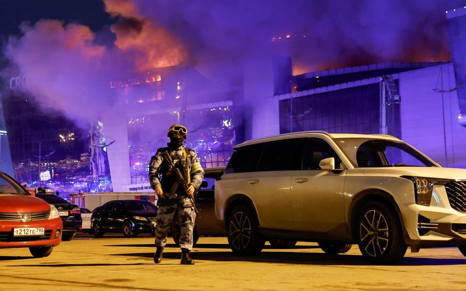 A Russian law enforcement officer walks the perimeter