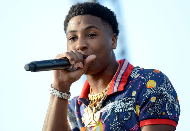 <p>Scott Dudelson/Getty</p> NBA Youngboy performs onstage during the Day N Night Festival on September 10, 2017 in Anaheim, California.