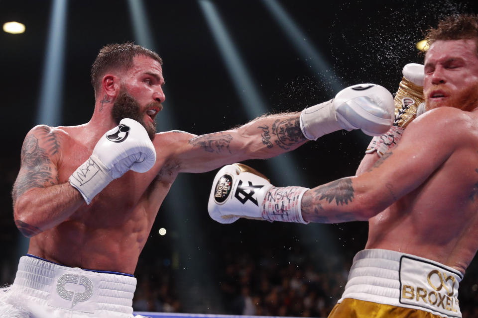 Caleb Plant lands a left to Canelo Alvarez, of Mexico, during a super middleweight title unification fight Saturday, Nov. 6, 2021, in Las Vegas. (AP Photo/Steve Marcus)