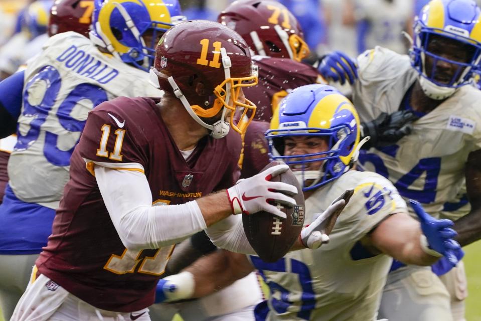 Washington Football Team's Alex Smith tries to get away from Los Angeles Rams' Troy Reeder during the second half of an NFL football game Sunday, Oct. 11, 2020, in Landover, Md. (AP Photo/Steve Helber)