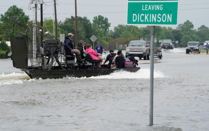 People are rescued by airboat in Dickinson, Texas, on Sunday. (Photo: Rick Wilking/Reuters)