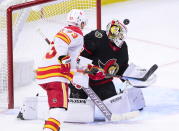 Ottawa Senators goaltender Matt Murray (30) looks for the puck as Calgary Flames centre Sam Bennett (93) moves towards the net during third period NHL hockey action in Ottawa on Monday, March 1, 2021. (Sean Kilpatrick/The Canadian Press via AP)