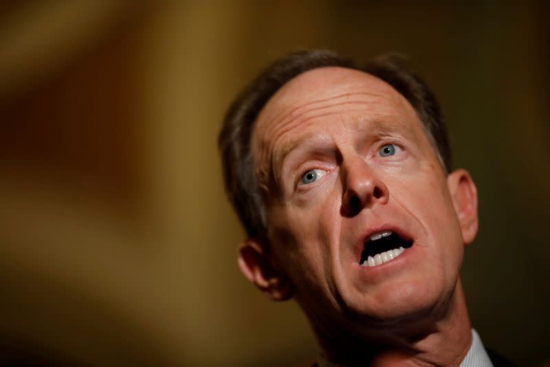 FILE PHOTO: Sen. Pat Toomey (R-PA) speaks with reporters following the party luncheons on Capitol Hill in Washington