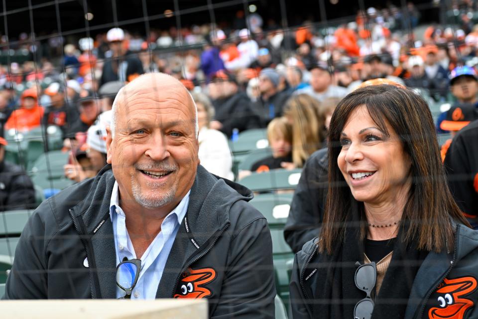 Former Baltimore Orioles player Cal Ripken, left, smiles for a photo with his wife Laura Kiessling before an opening day baseball game against the New York Yankees, Friday, April 7, 2023, in Baltimore.