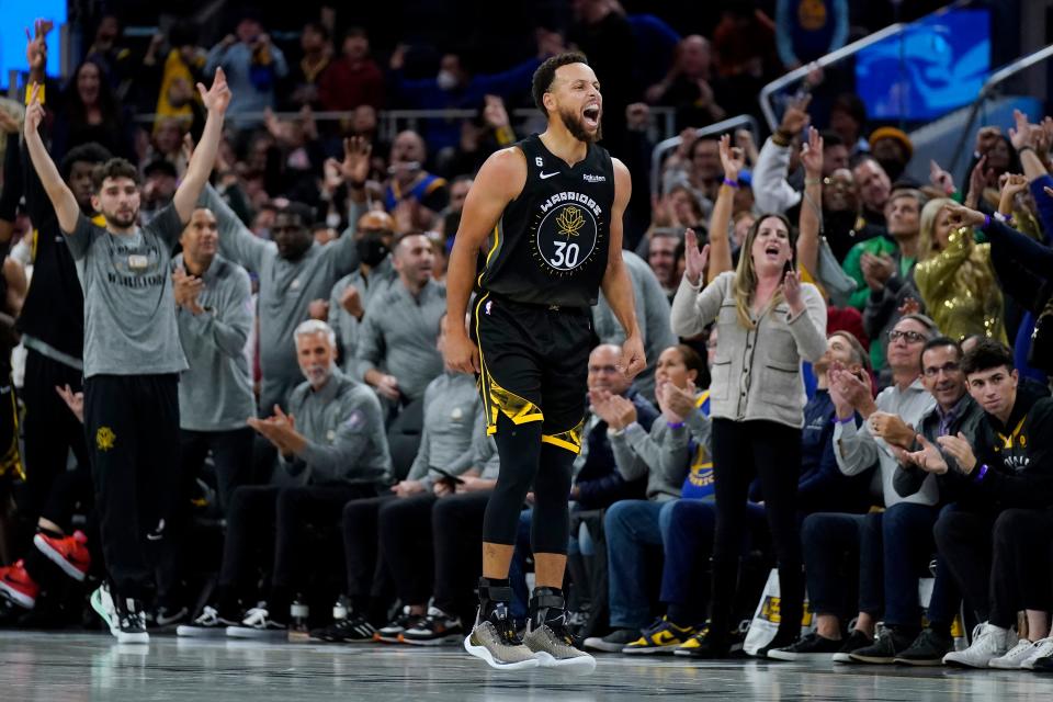 Golden State Warriors guard Stephen Curry reacts after making a 3-pointer against the Cleveland Cavaliers during the second half in San Francisco, Friday, Nov. 11, 2022.