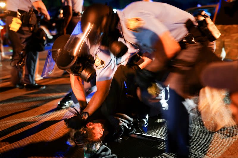 Police detain protesters for blocking traffic during a rally against racial inequality and the police shooting death of Rayshard Brooks, in Atlanta